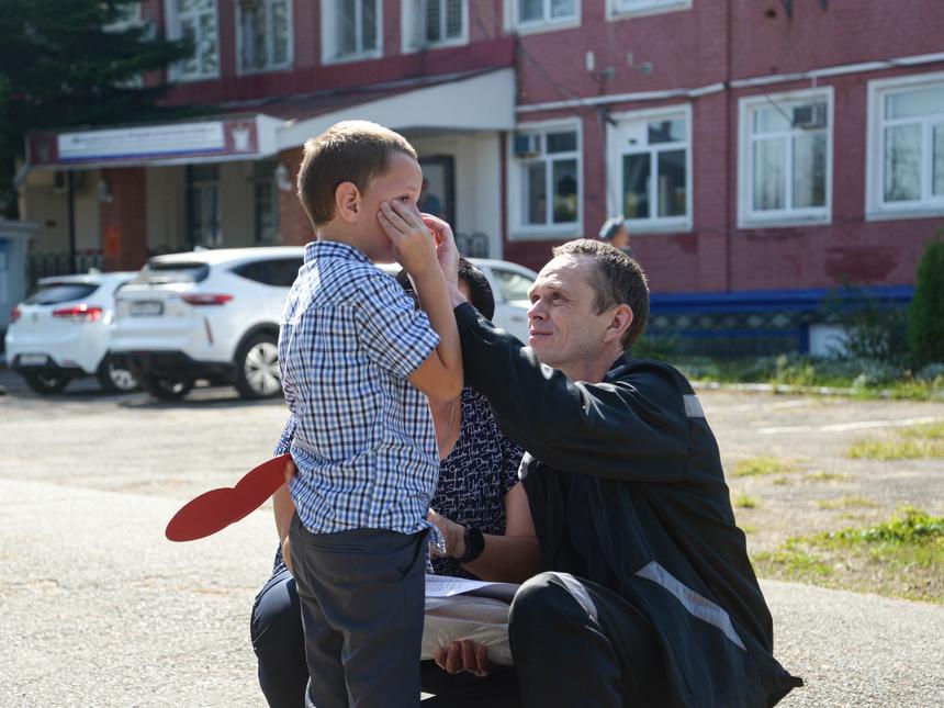Maksim Beltikov is wiping tears from his son's face