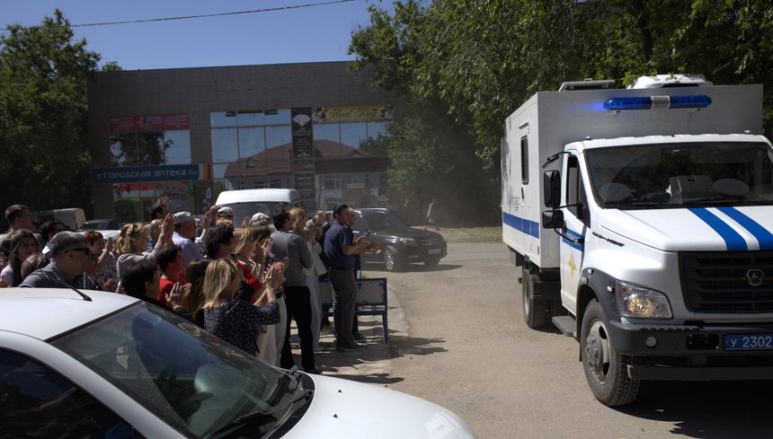 Aleksey Shcherbich&rsquo;s friends near the police van, which is taking the believer to the hearing, May 21, 2025